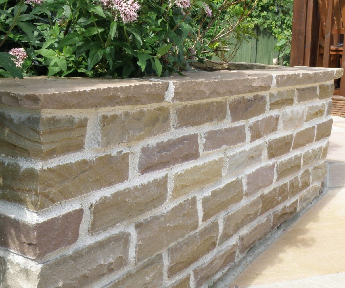 Natural-Paving-Cottagestone-Lakeland-Walling-used-as-Retaining-Wall-with-Planting-scaled