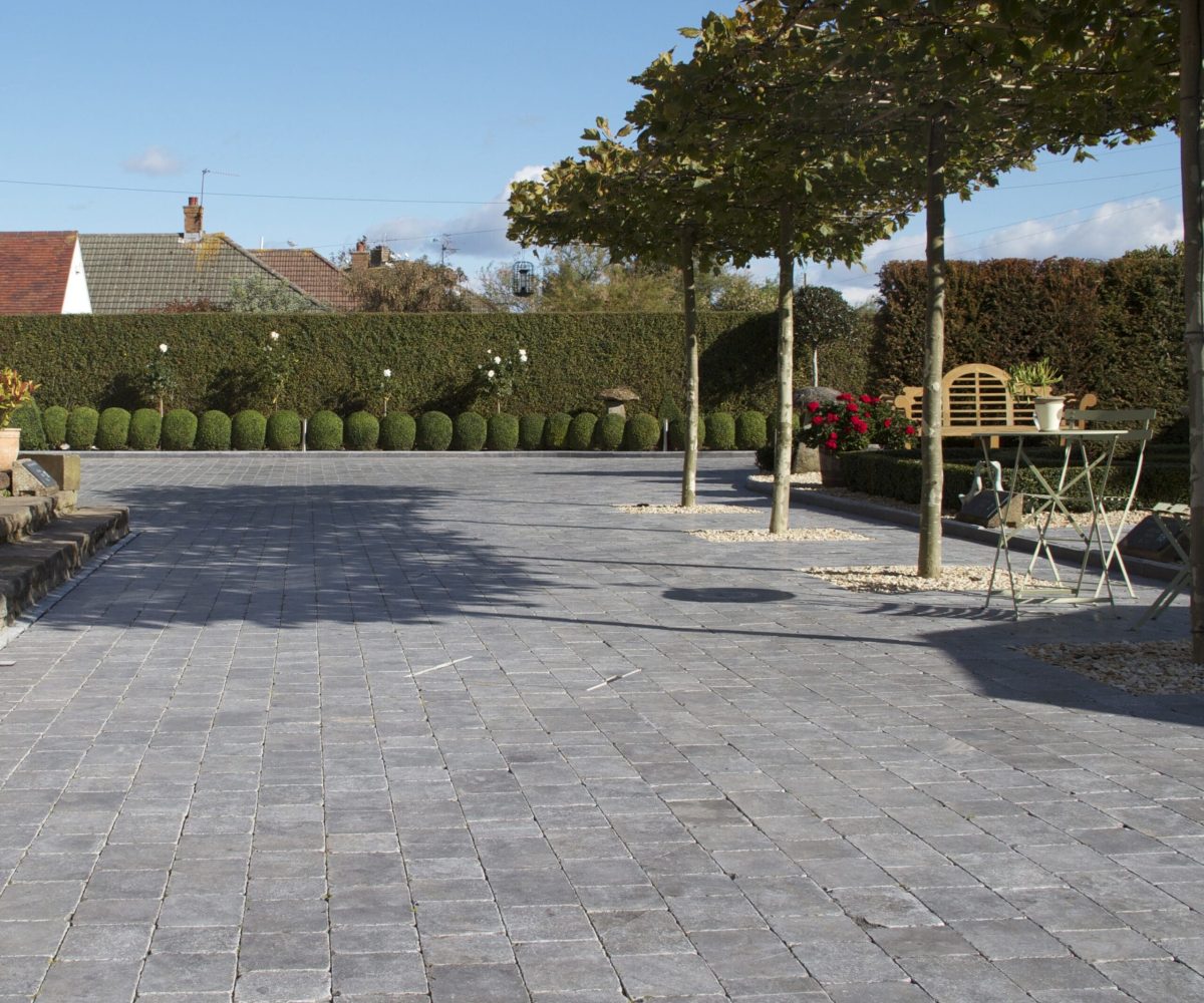 Natural-Paving-Fossestone-Midnight-Blue-Block-Paving-Driveway-with-bordering-Treeline-scaled-2.jpg