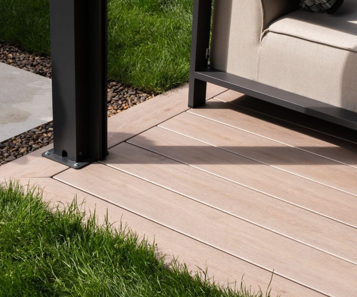 Pioneer-Darker-Oak-Patio-Decking-corner-with-gravel-and-grass-border-scaled-1.jpg