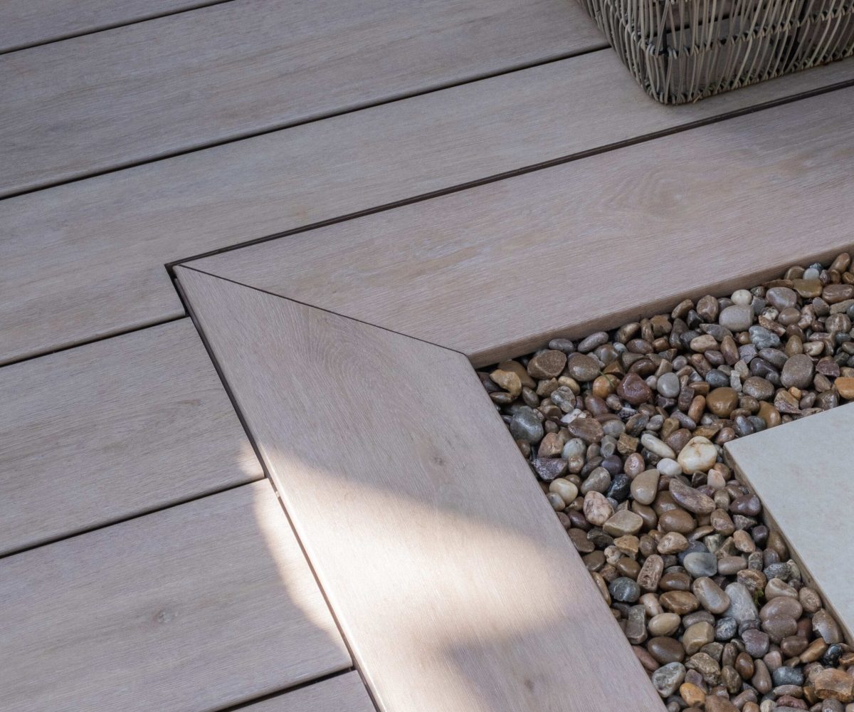 Pioneer-Darker-Oak-Patio-Decking-corner-with-gravel-border-scaled-2.jpg